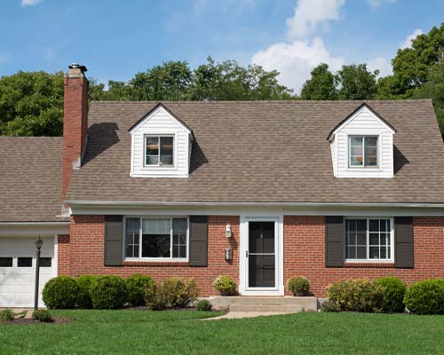 Red brick home with light shingled roof