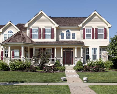 White siding home with red window panes